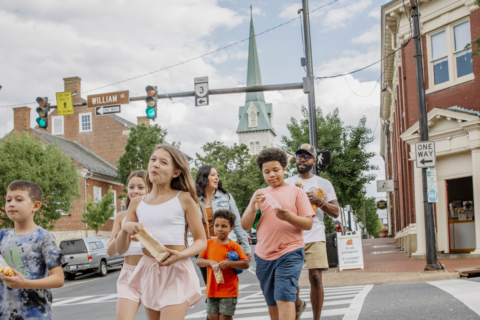 family walking in crosswalk in Fredericksburg