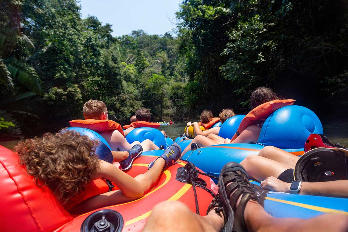 family floating down river on tubes