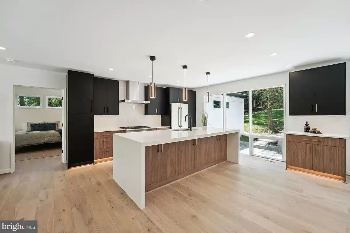 white kitchen with black and wood cabinets and white quartz countertops