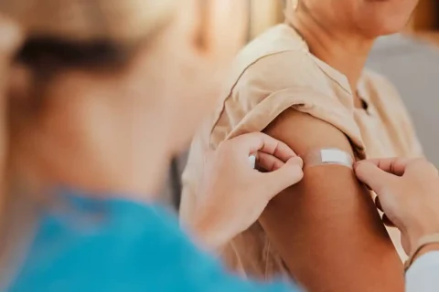person after getting a flu shot. bandaid on arm