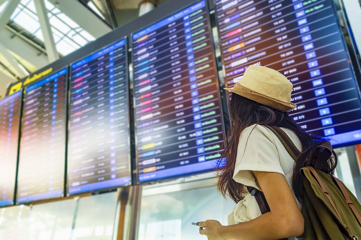 woman looking at flights at airport