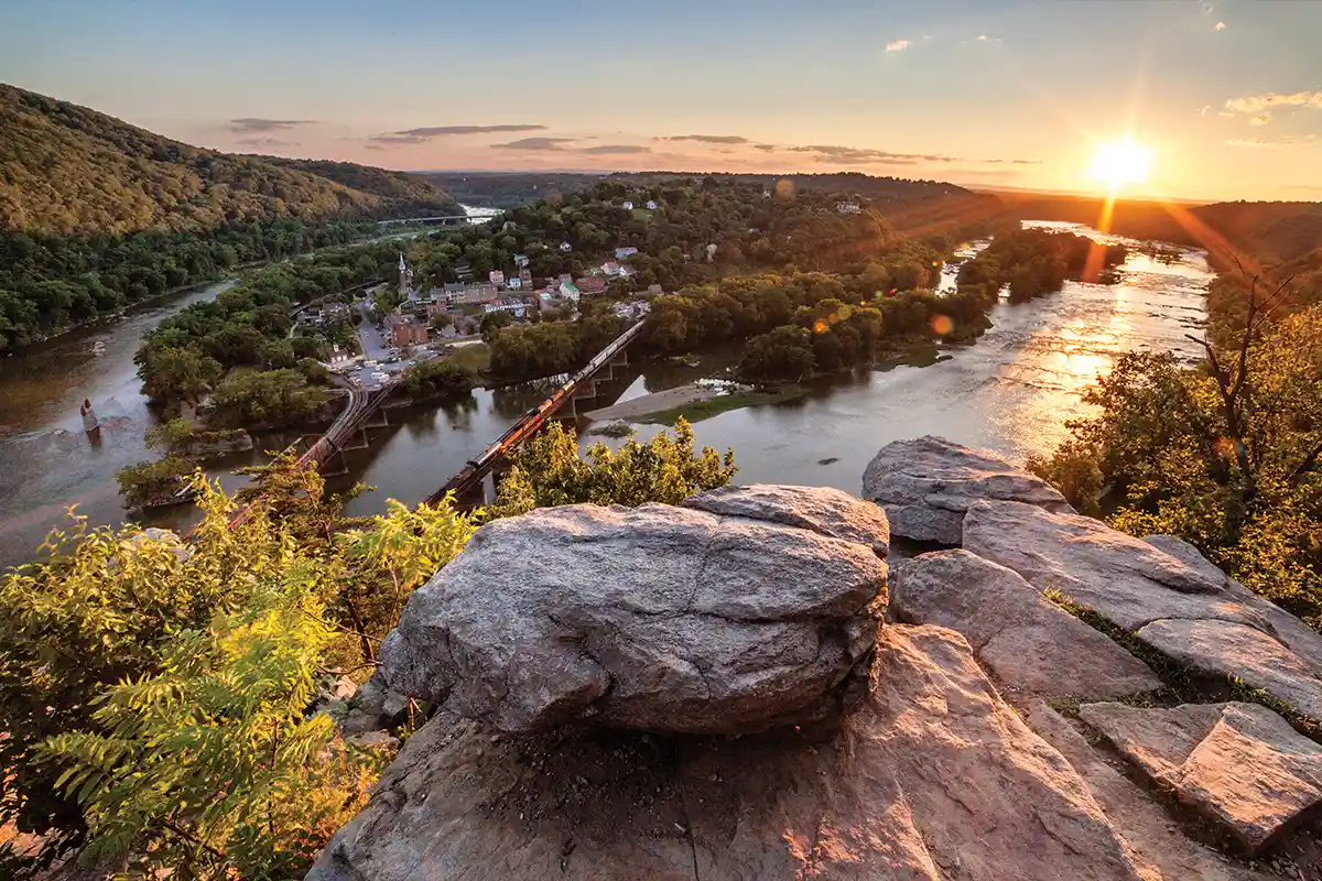overlook of harpers ferry at sunset from across the river