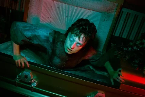 person coming out of coffin