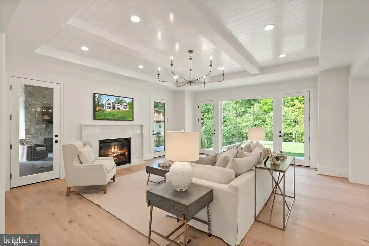 white family room with light wood floors and gas fireplace