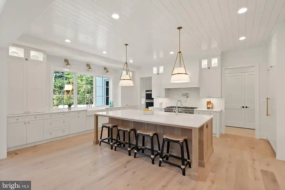 white kitchen with floor-to-ceiling cabinets and large island