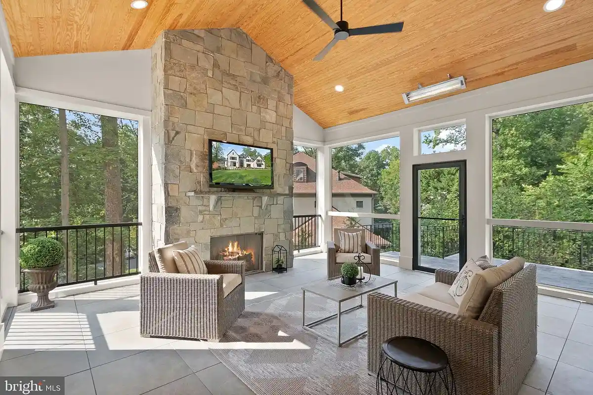 screened porch with gas fireplace and wood pannel ceiling
