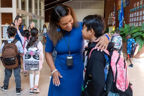 Principal Gadley hugs a student