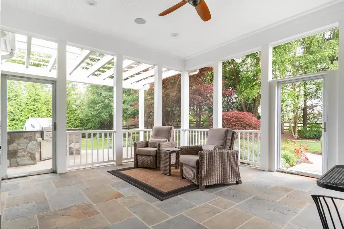 screened-porch with two lounge chairs