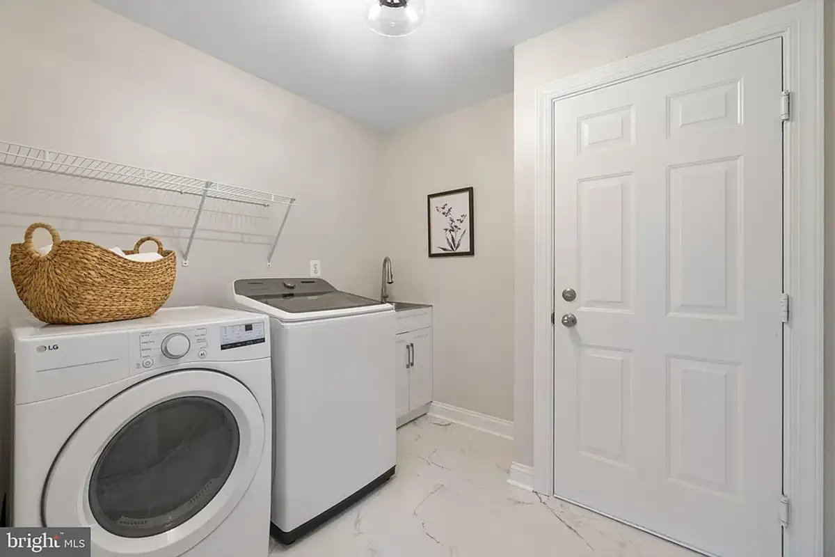 Washer and dryer, plus utility sink.