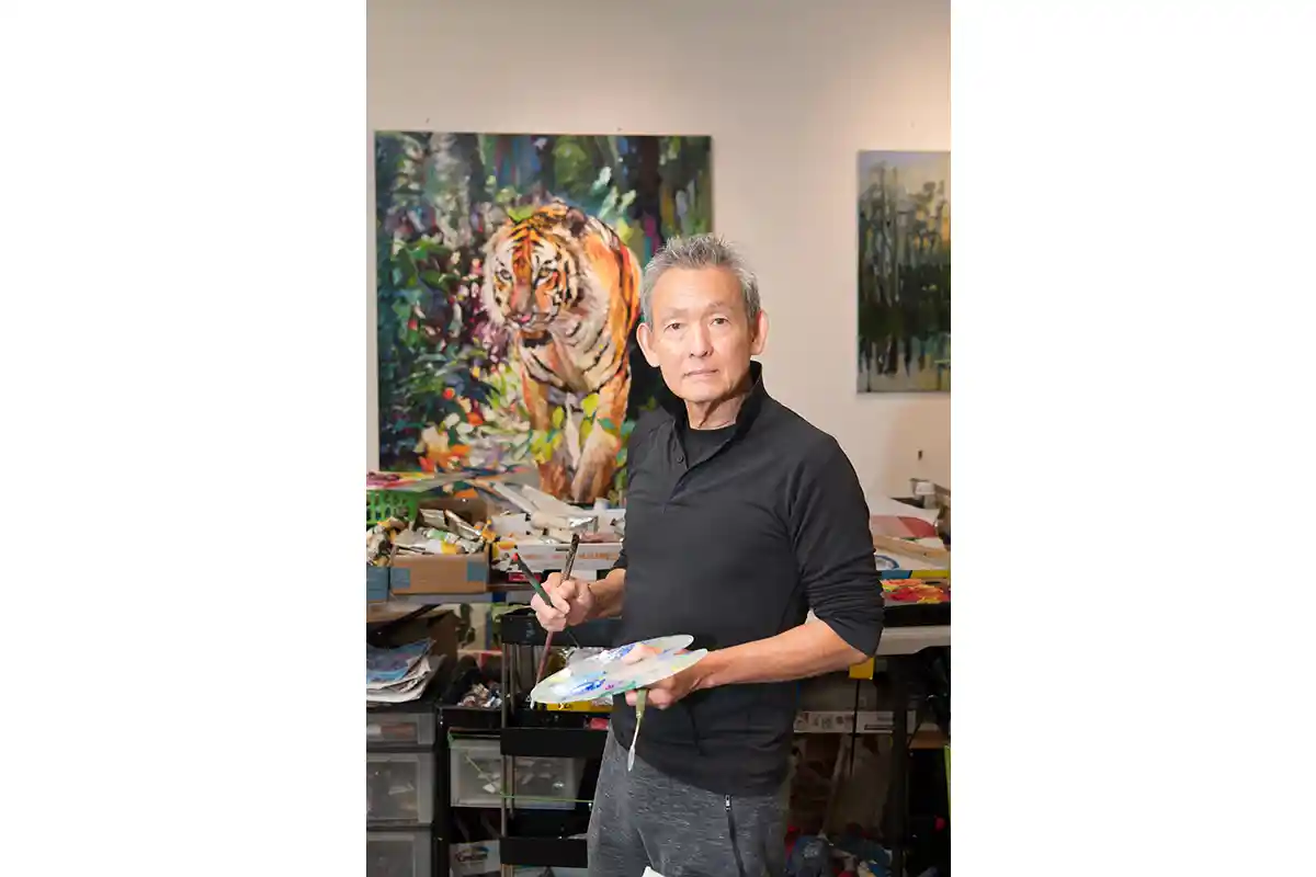 Pakan Penn in front of his tiger painting