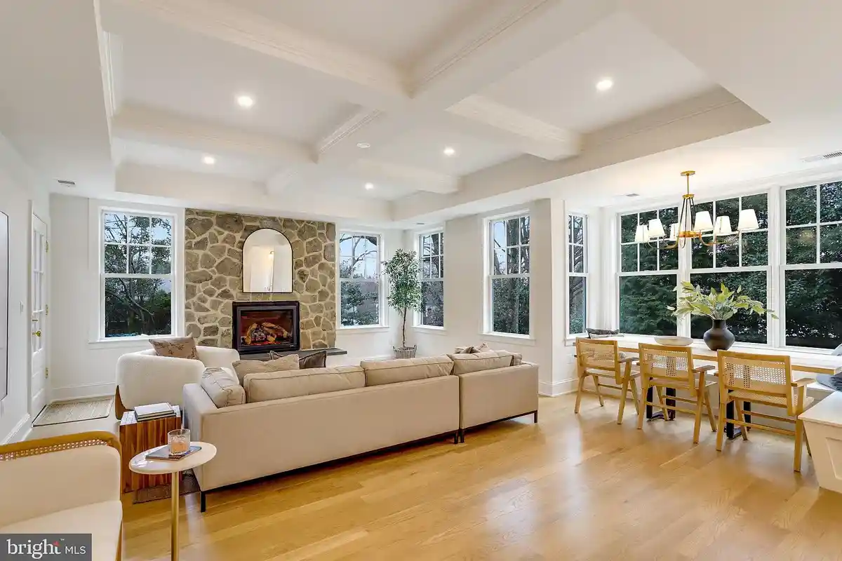 living room with stone fireplace and breakfast nook
