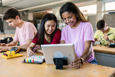 Group of diverse teenage students learning together