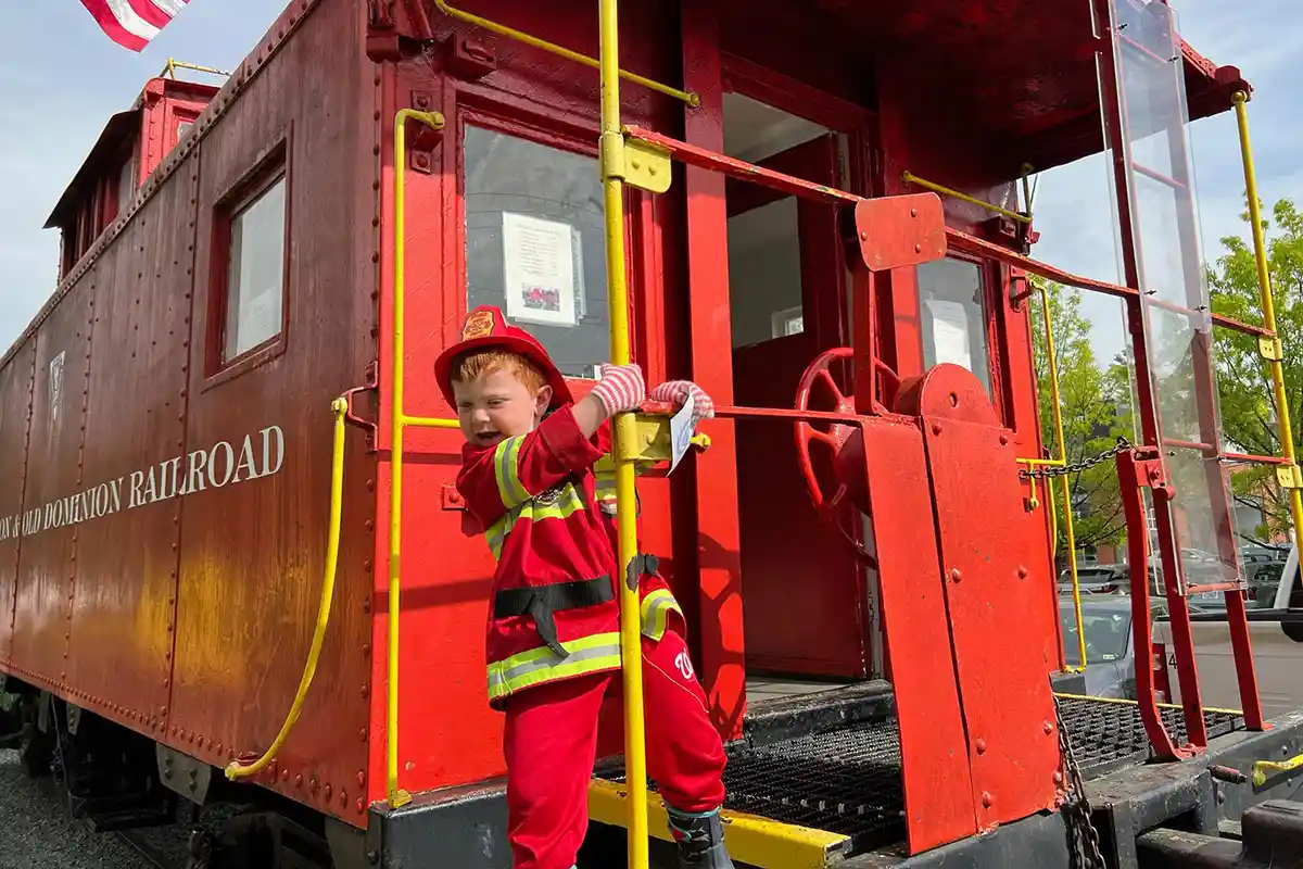 WO&D Trail boy in fireman's outfit on caboose in Vienna