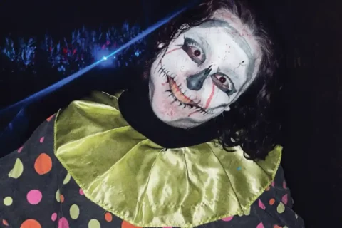 haunted house scarer in clown outfit/makeup