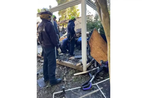 Firefighters rescue dog from rubble of Haymarket home.