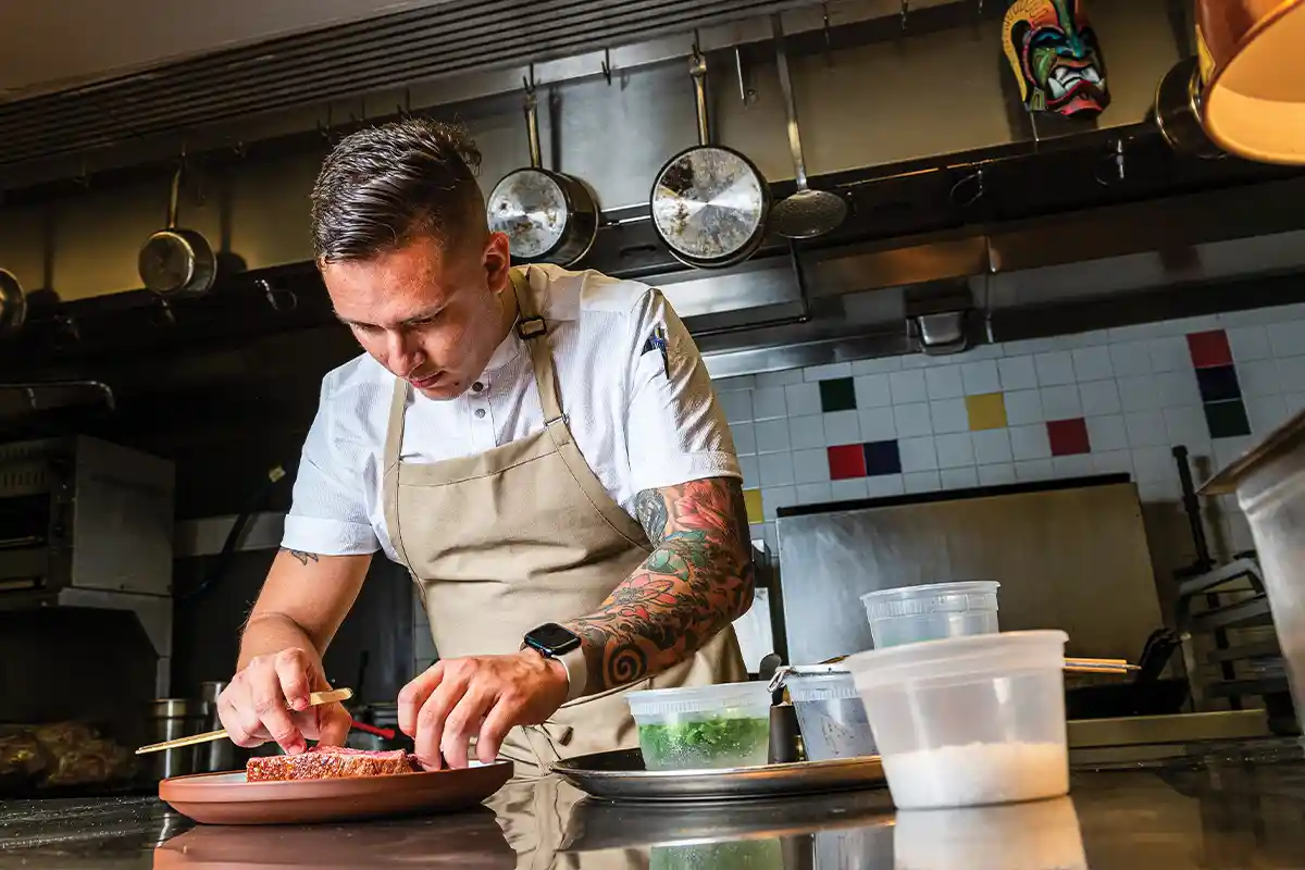 the study chef plating a steak