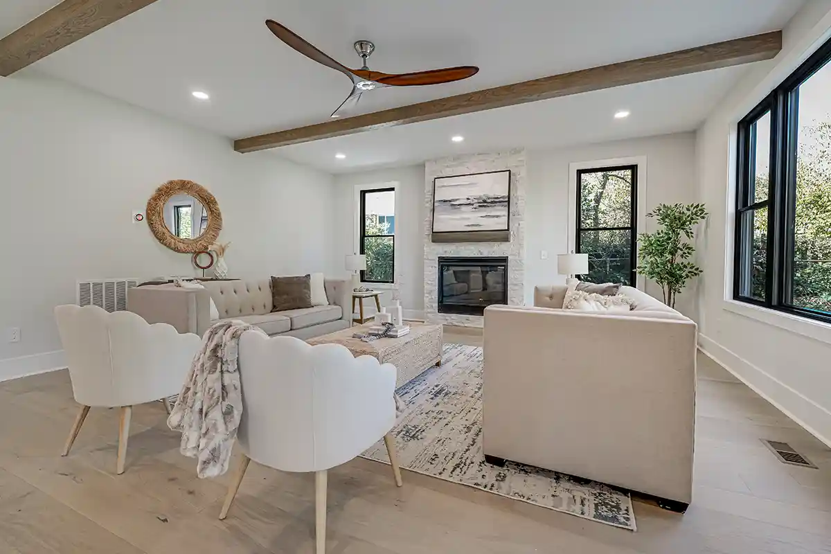 living room with gas fireplace and wood beams