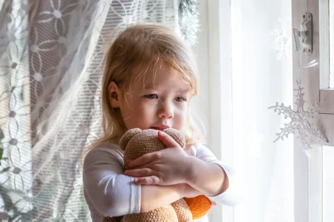 Child experiencing holiday stress and sadness