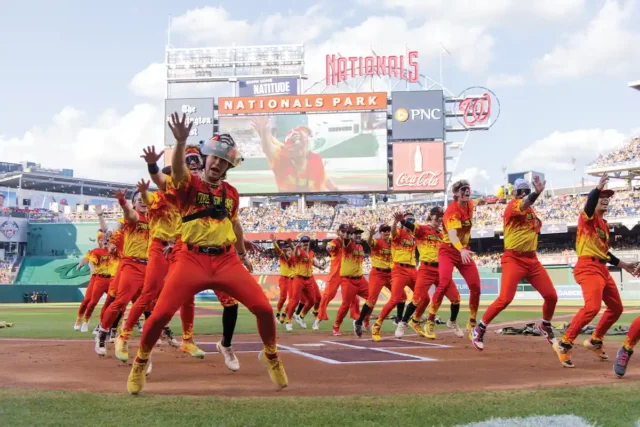 The Firefighters team dance at Nats Stadium during a Savannah Bananas game