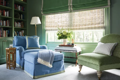 A blue chaise longue and a green chair