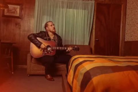 huntley posing with guitar