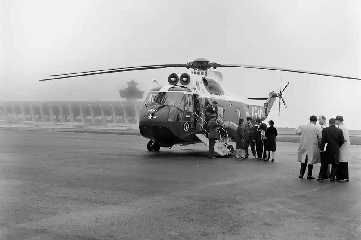 kennedy walking off helicopter at dulles