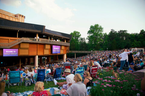 People sit on the lawn at Wolf Trap.