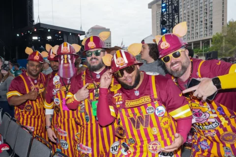 Washington Commanders fans pose for a picture during the NFL Draft 2023 Thursday Day 1 on April 27, 2023, at Union Station in Kansas City.