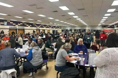 parents sitting in cafeteria during fcps school boundaries meeting