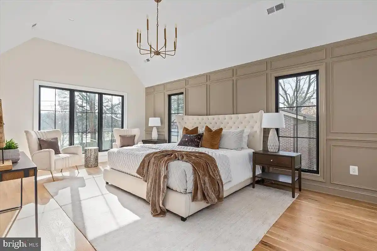 bedroom with accent walls and trim details