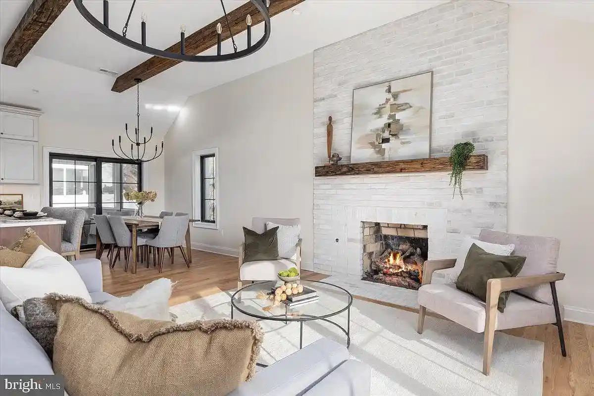 family room with fireplace and wood beams on ceiling