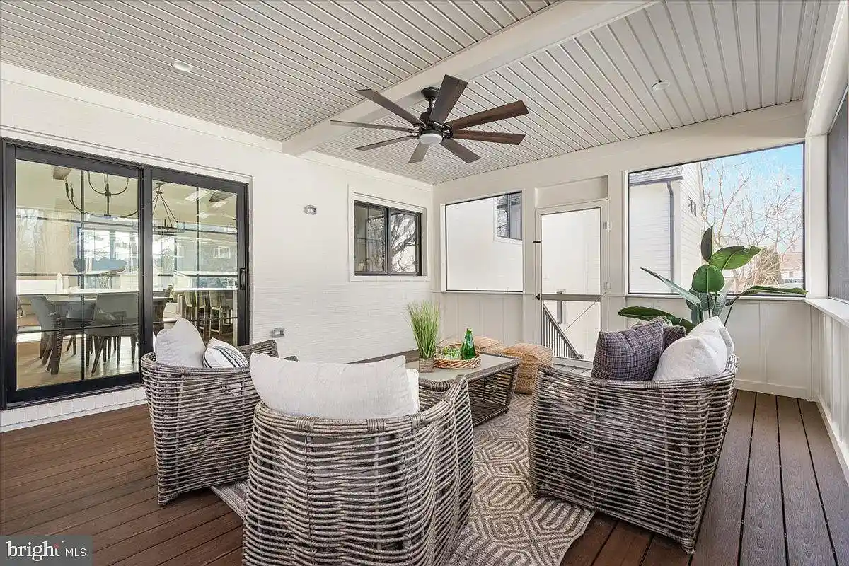screened-in porch with dark flooring and ceiling fan