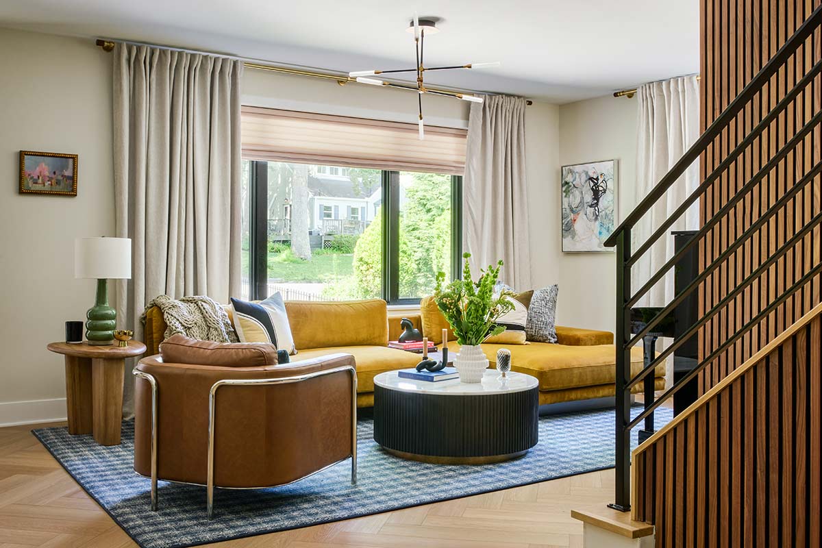 living room with gold sofa and blue rug