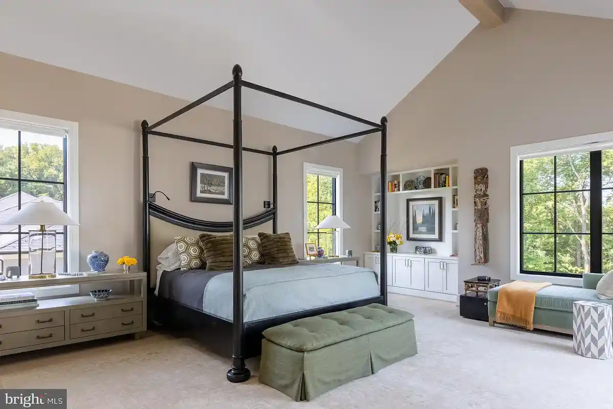 owner's bedroom with built-in shelving and cathedral ceiling