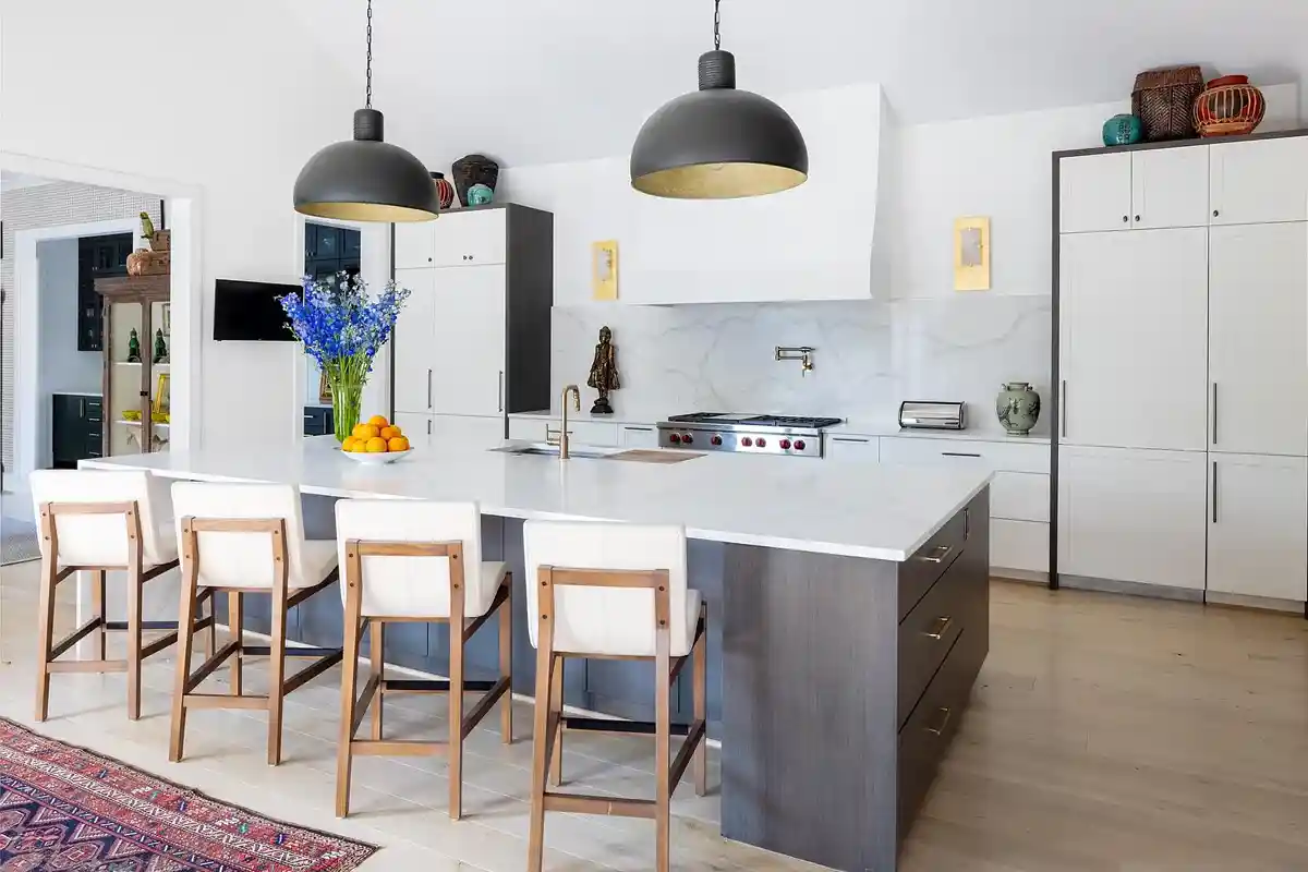 kitchen with white marble island and backsplash, white cabintets