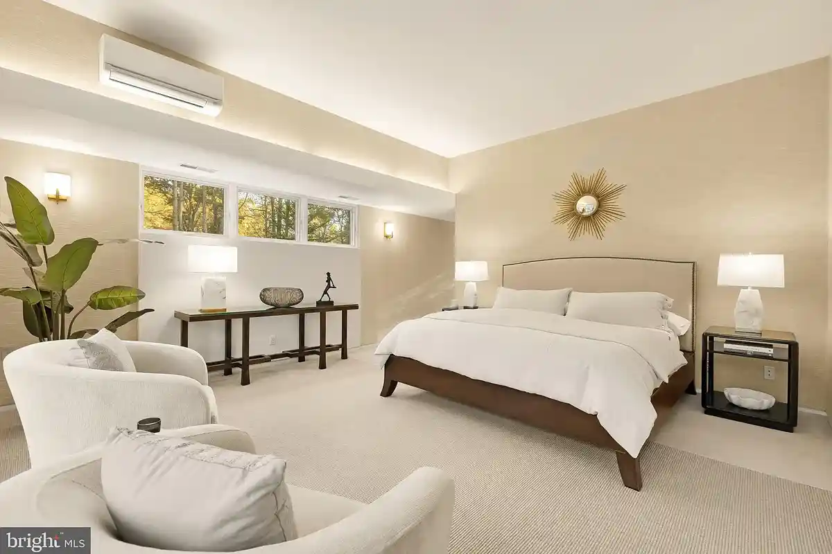 primary suite with bed and chairs