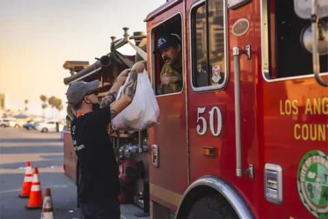 world central kitchen giving food to la firefighter