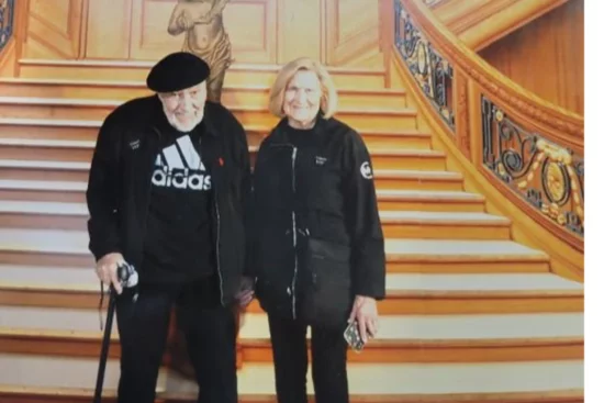 Ed and Helen Okuna standing in front of staircase at Titanic Exhibit