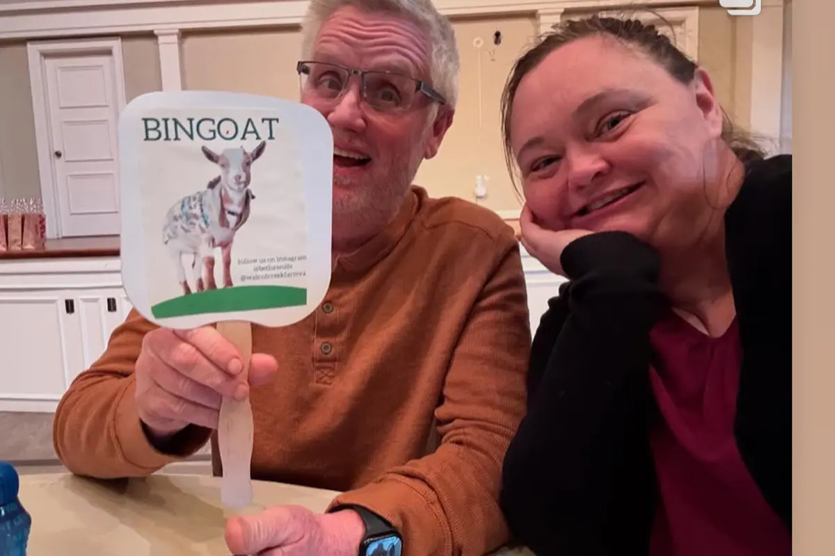 Man holds up BINGOAT sign at goat bingo