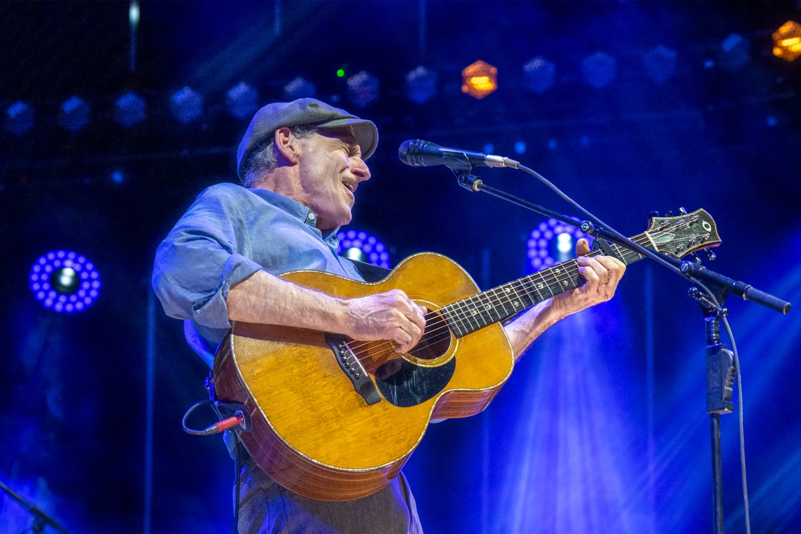 James Taylor on stage playing guitar
