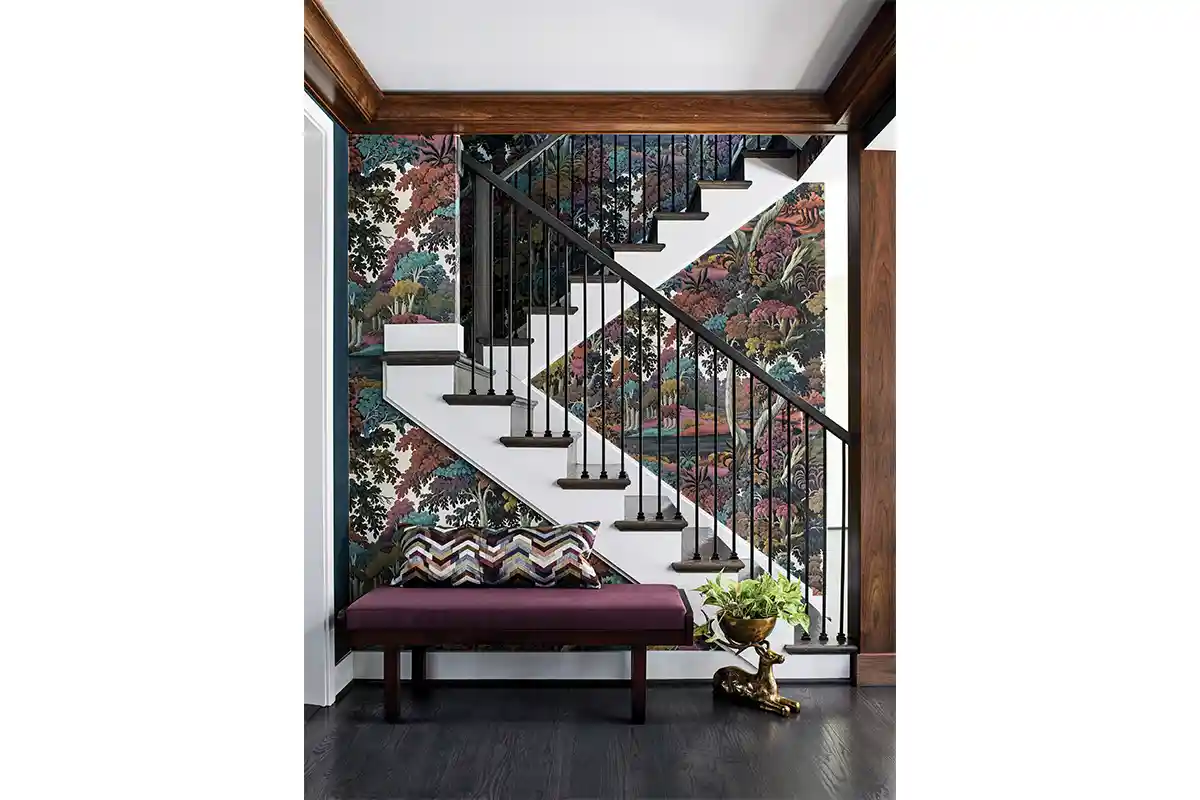 staircase with jewel-toned wallpaper with botanical design