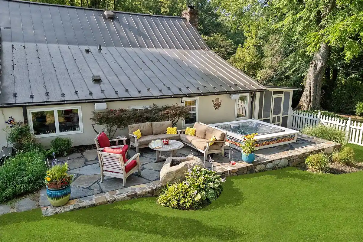 stone terrace with fire pit and sunken spa