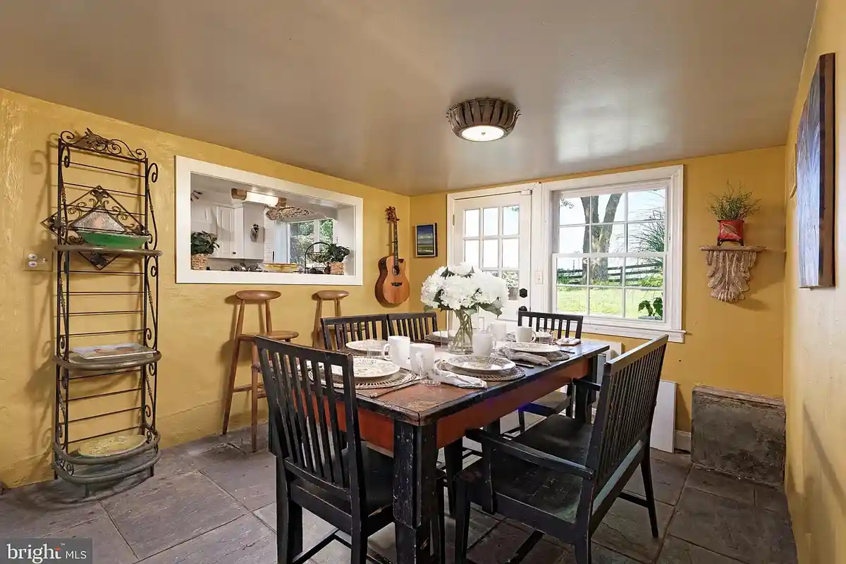 yellow breakfast room with pass through to kitchen
