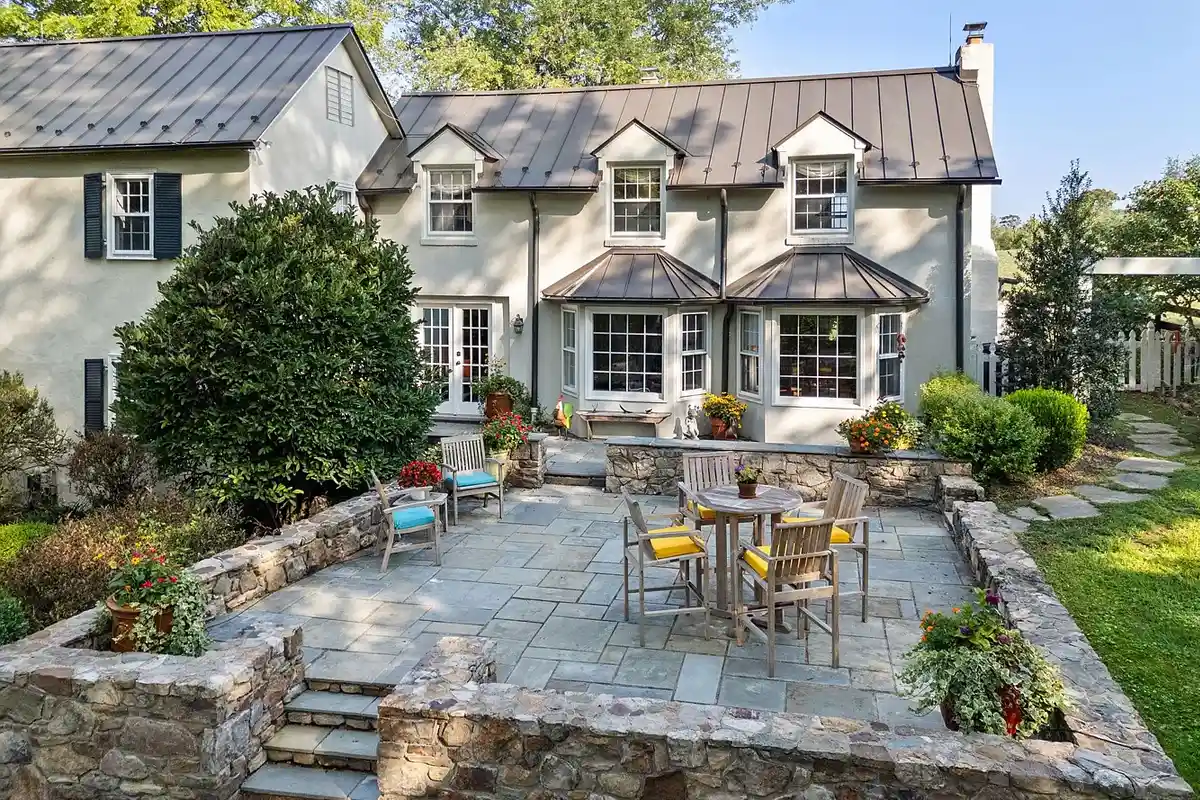 flagstone terrace with patio furniture in front of house