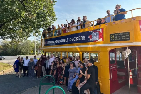 maryland double deckers bus with people on top and bottom