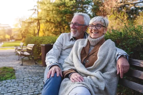 senior couple sitting on a bench