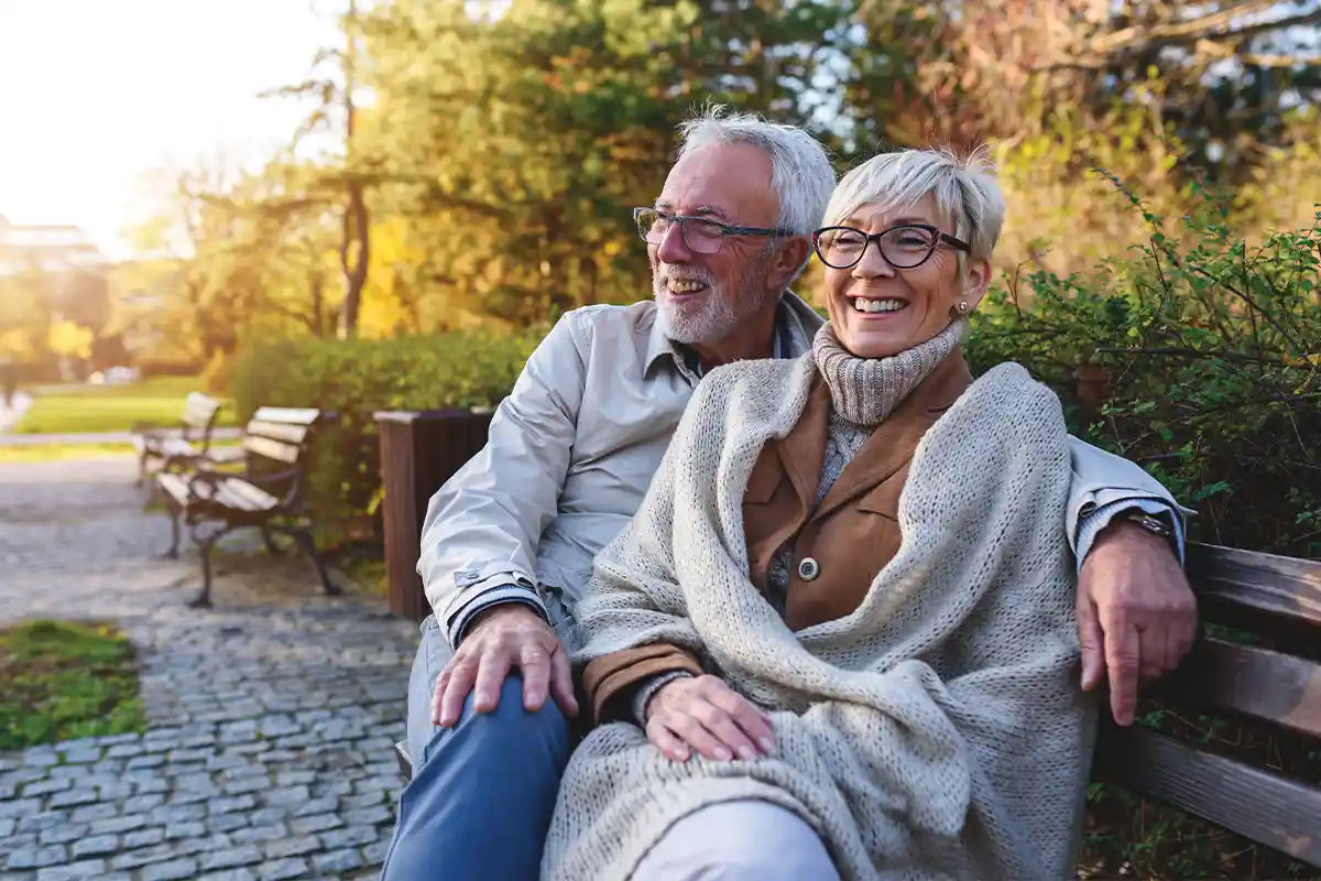 senior couple sitting on a bench