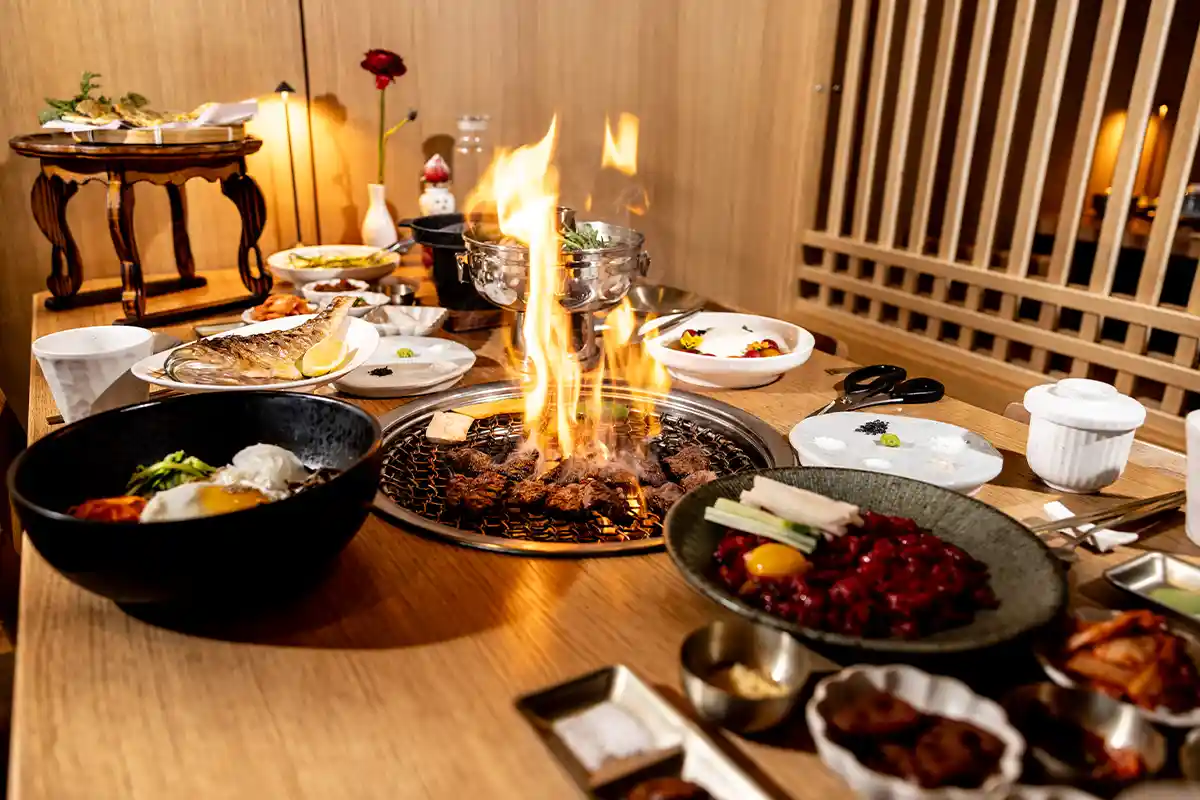 table with grill cooking meats