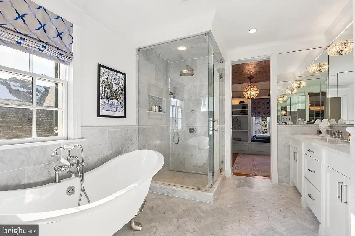 primary bath with walk-in shower and clawfoot bathtub
