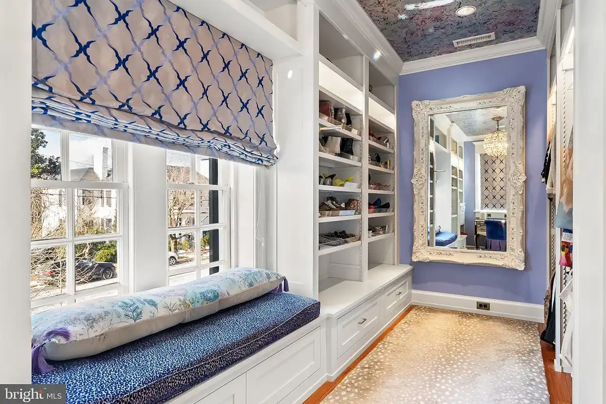 walk-in closet with white shelving and light purple walls